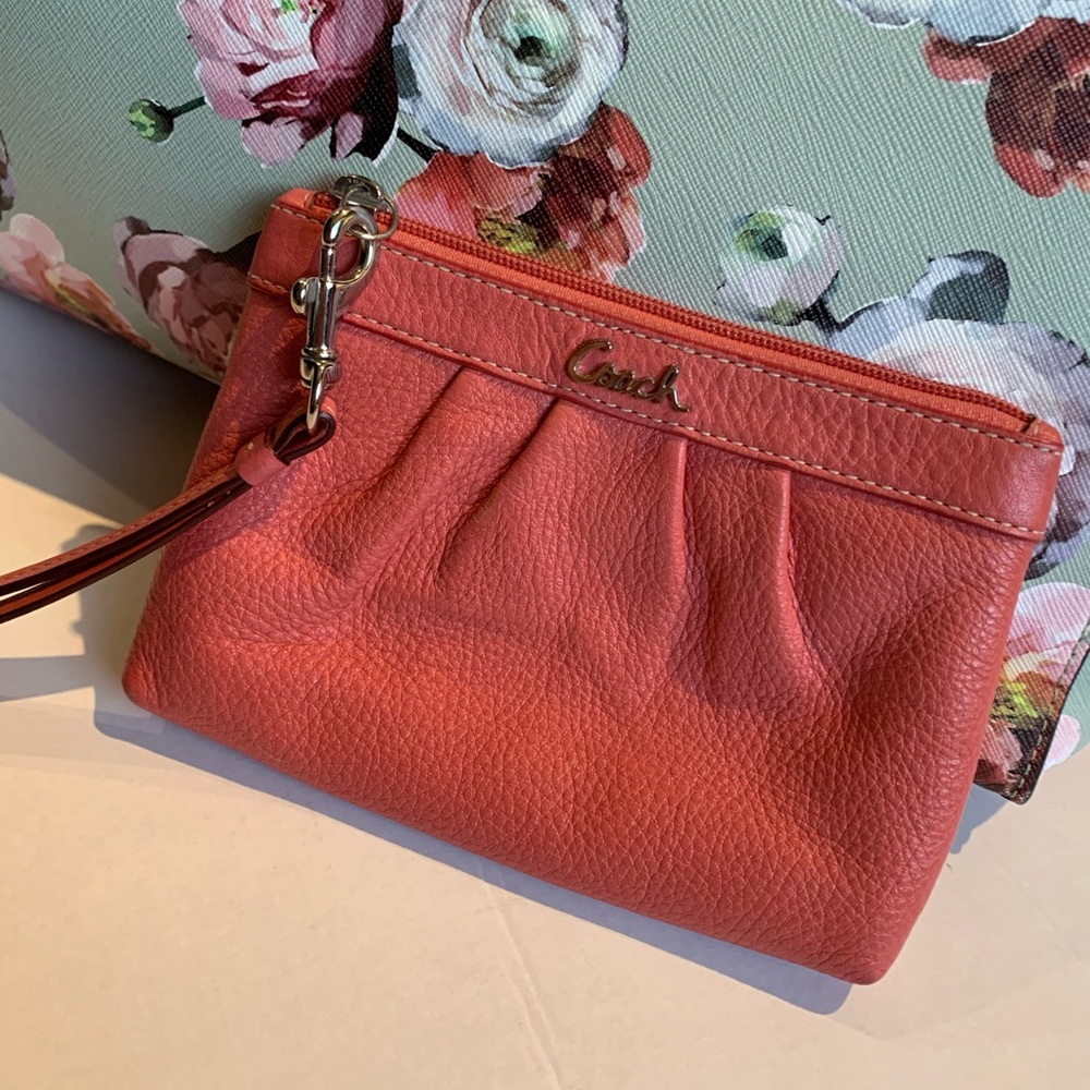 Coach muted coral wristlet